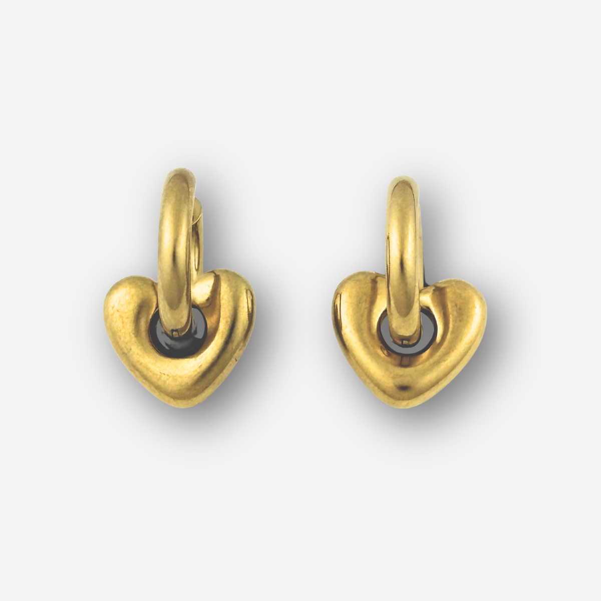 Pair of gold heart-shaped earrings on a white background