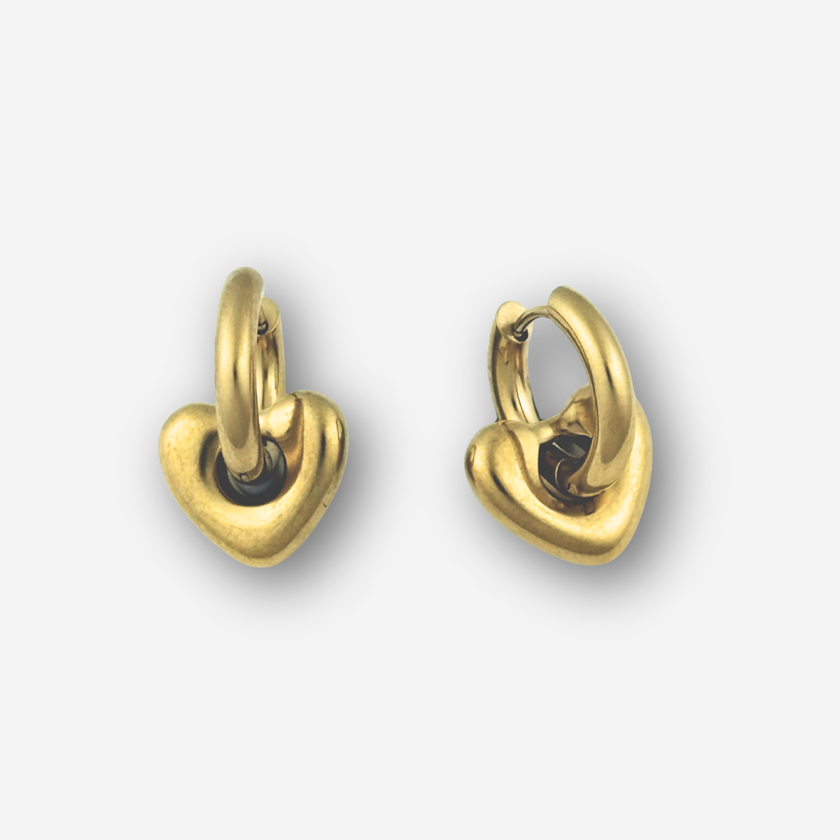Pair of gold heart-shaped hoop earrings on a light gray background