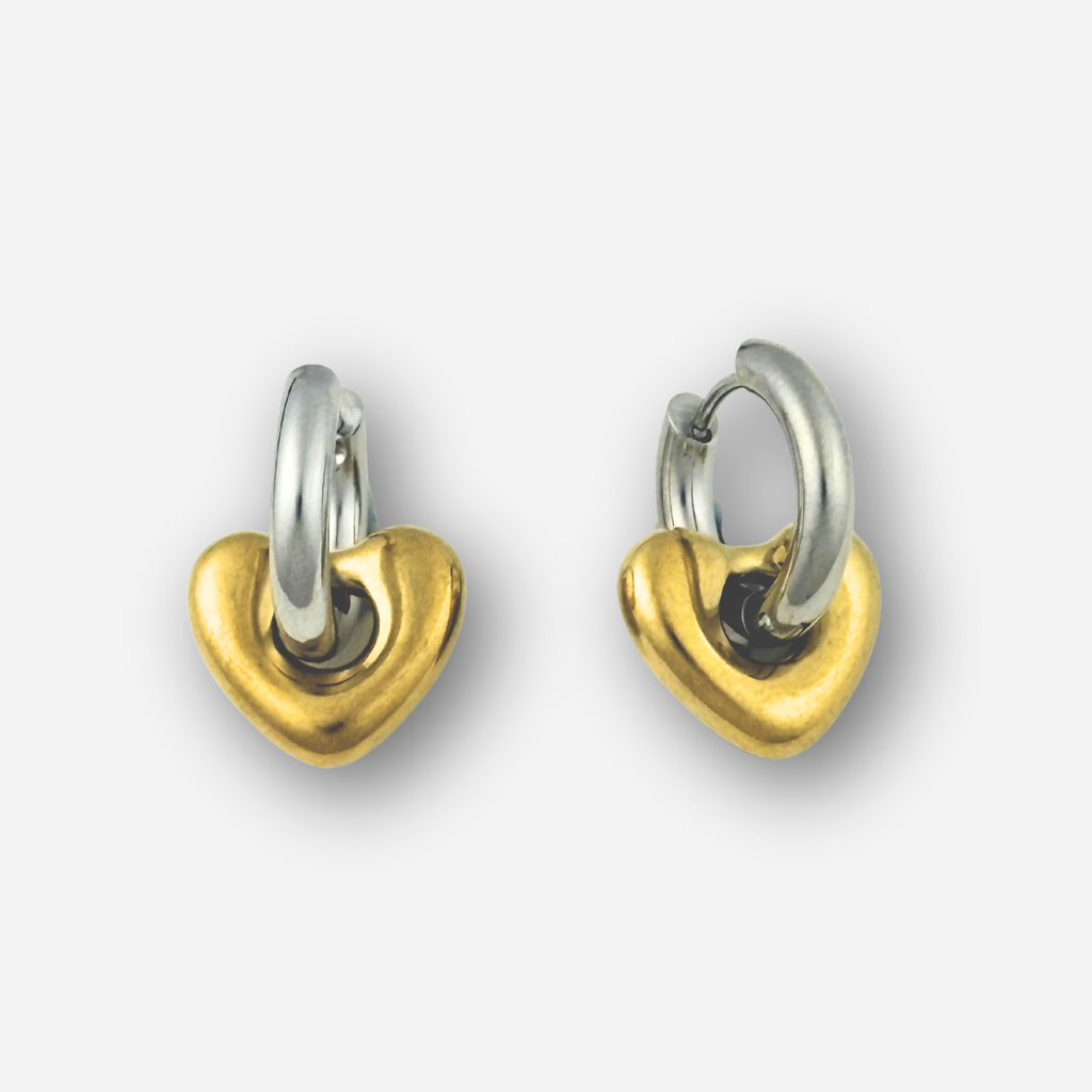 Heart-shaped earrings with gold and silver finish on a white background