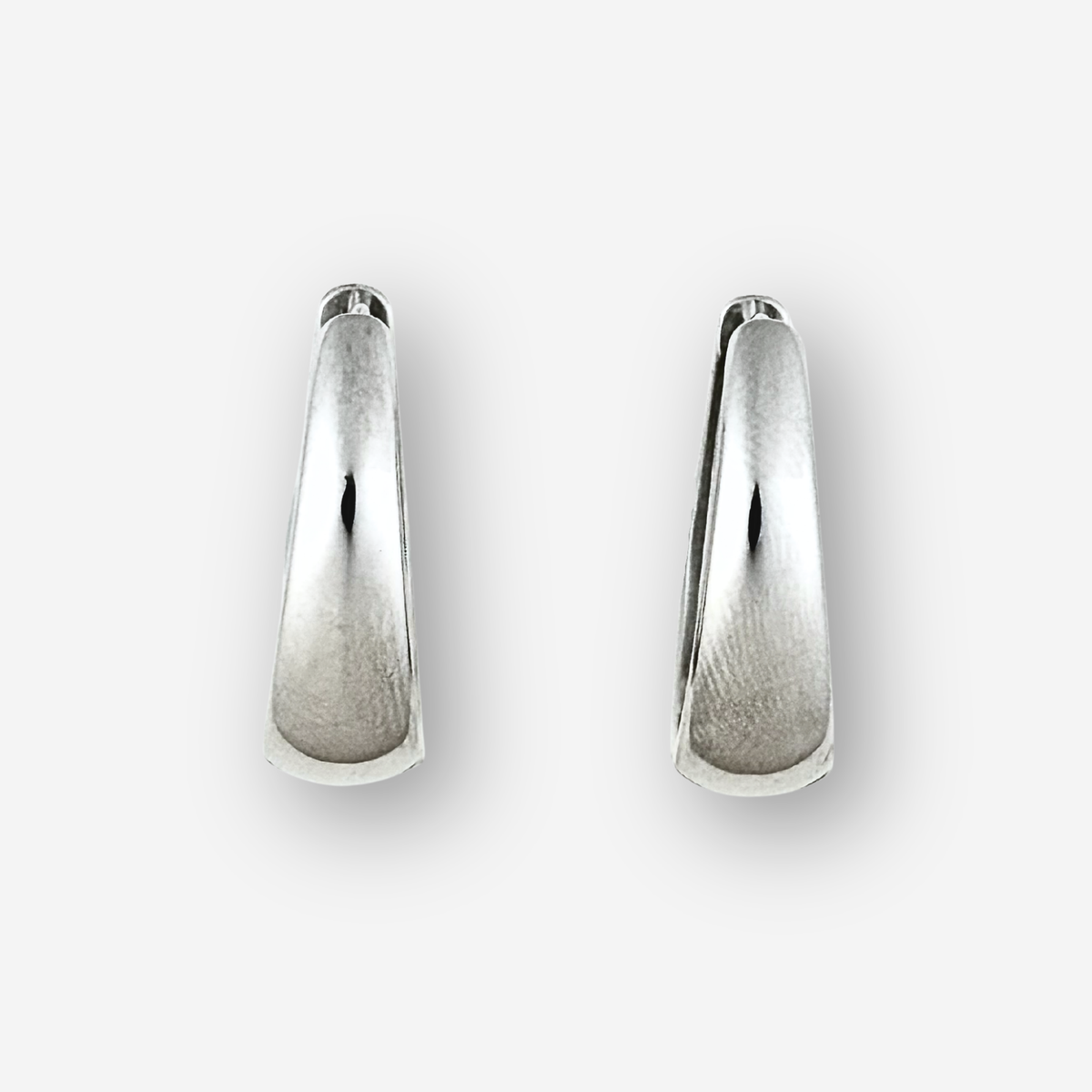 Pair of silver earrings on a white background