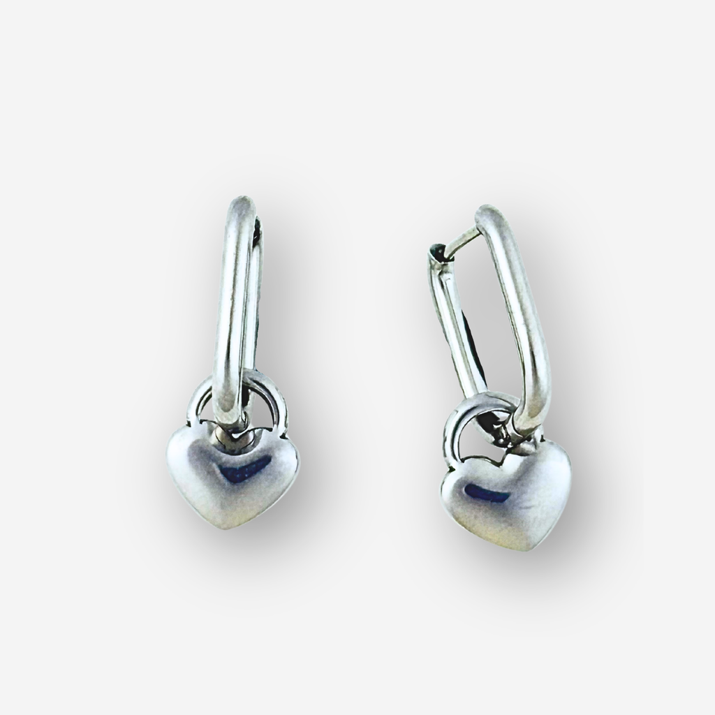 Pair of silver heart-shaped earrings on a white background