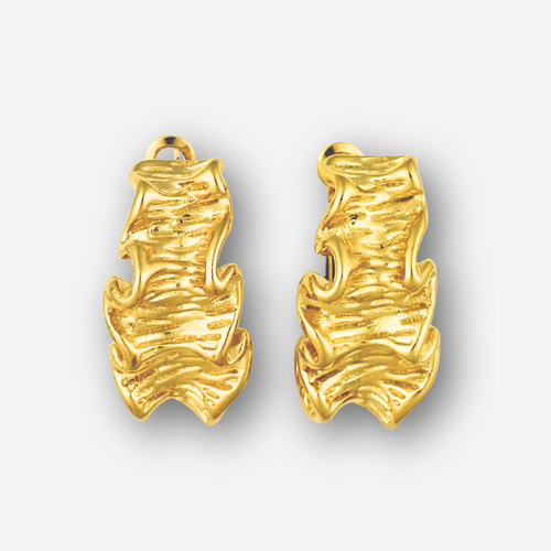Pair of large gold crinkle earrings on a light gray background