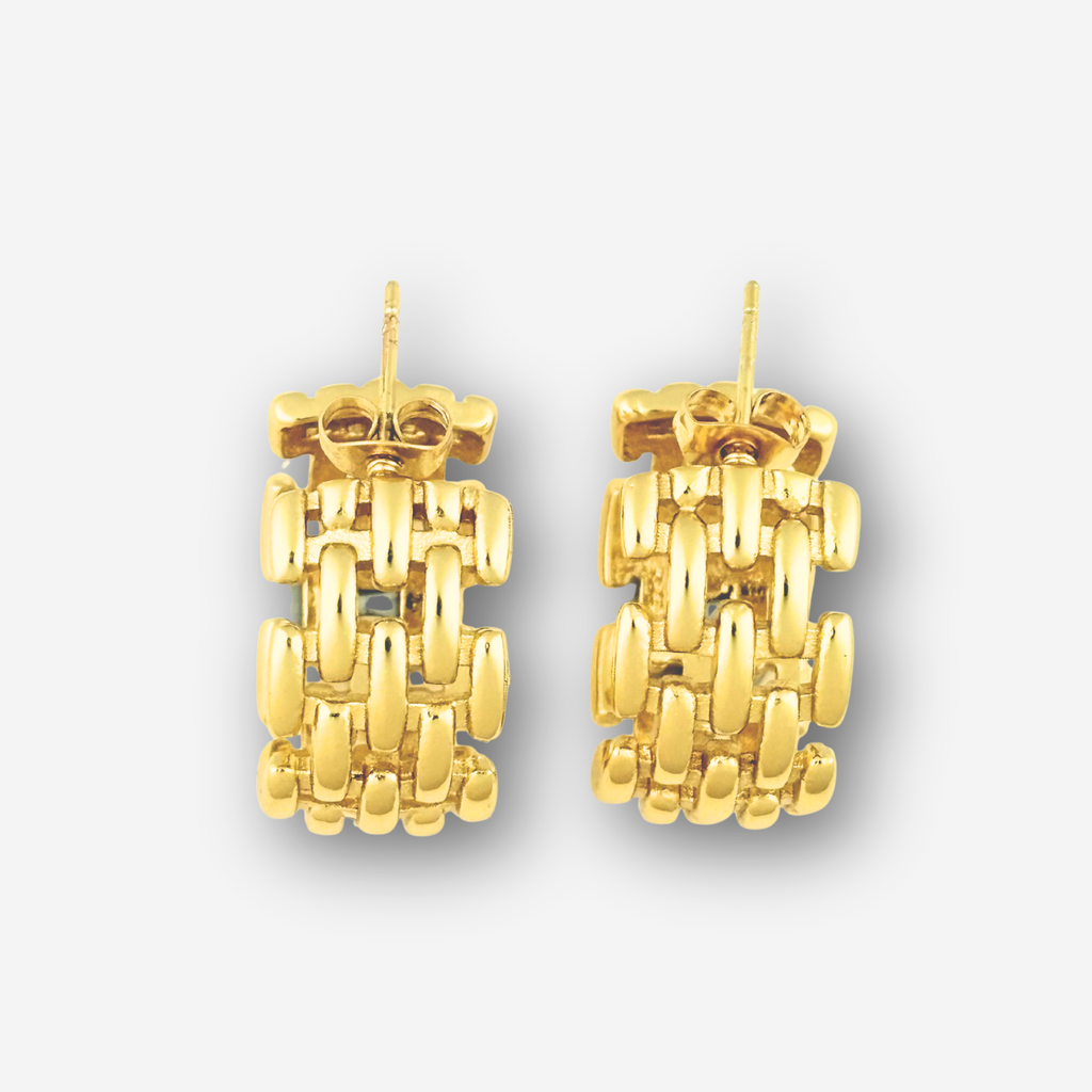 Pair of gold earrings on a light gray background