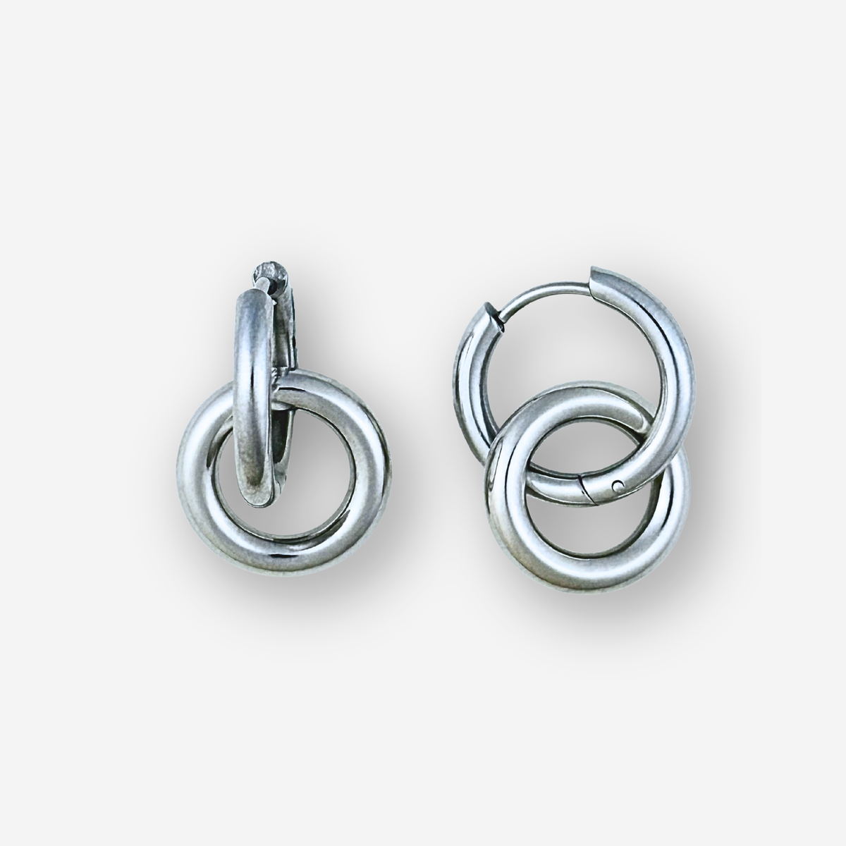Pair of silver hoop earrings on a white background
