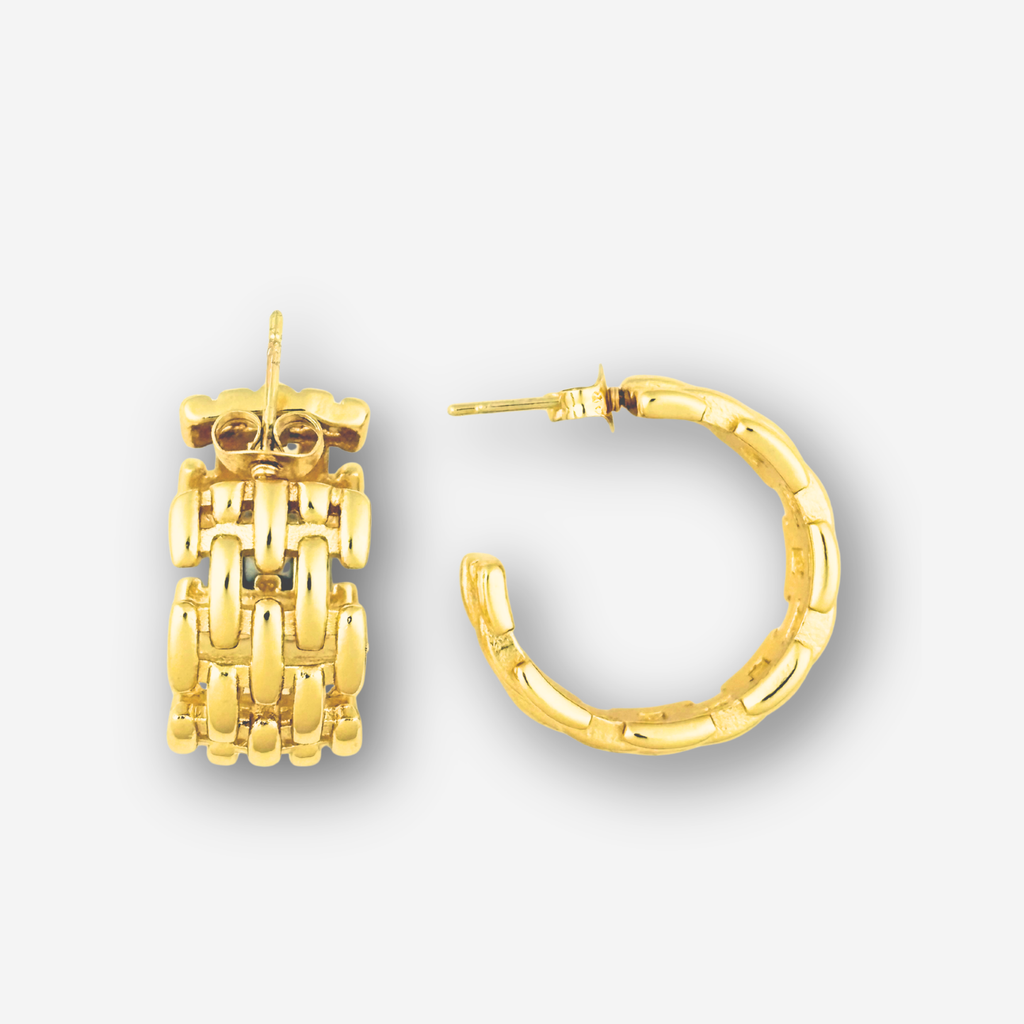 Gold hoop earrings on a light gray background