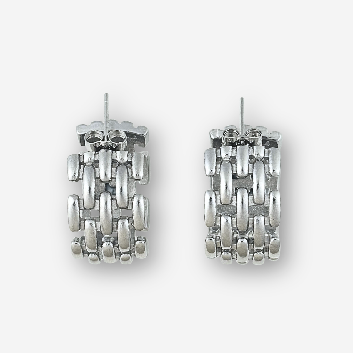 Pair of silver hoop earrings on a white background