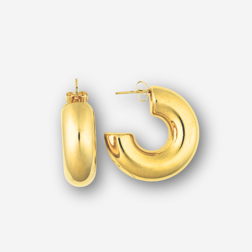 Gold hoop earrings on a light gray background