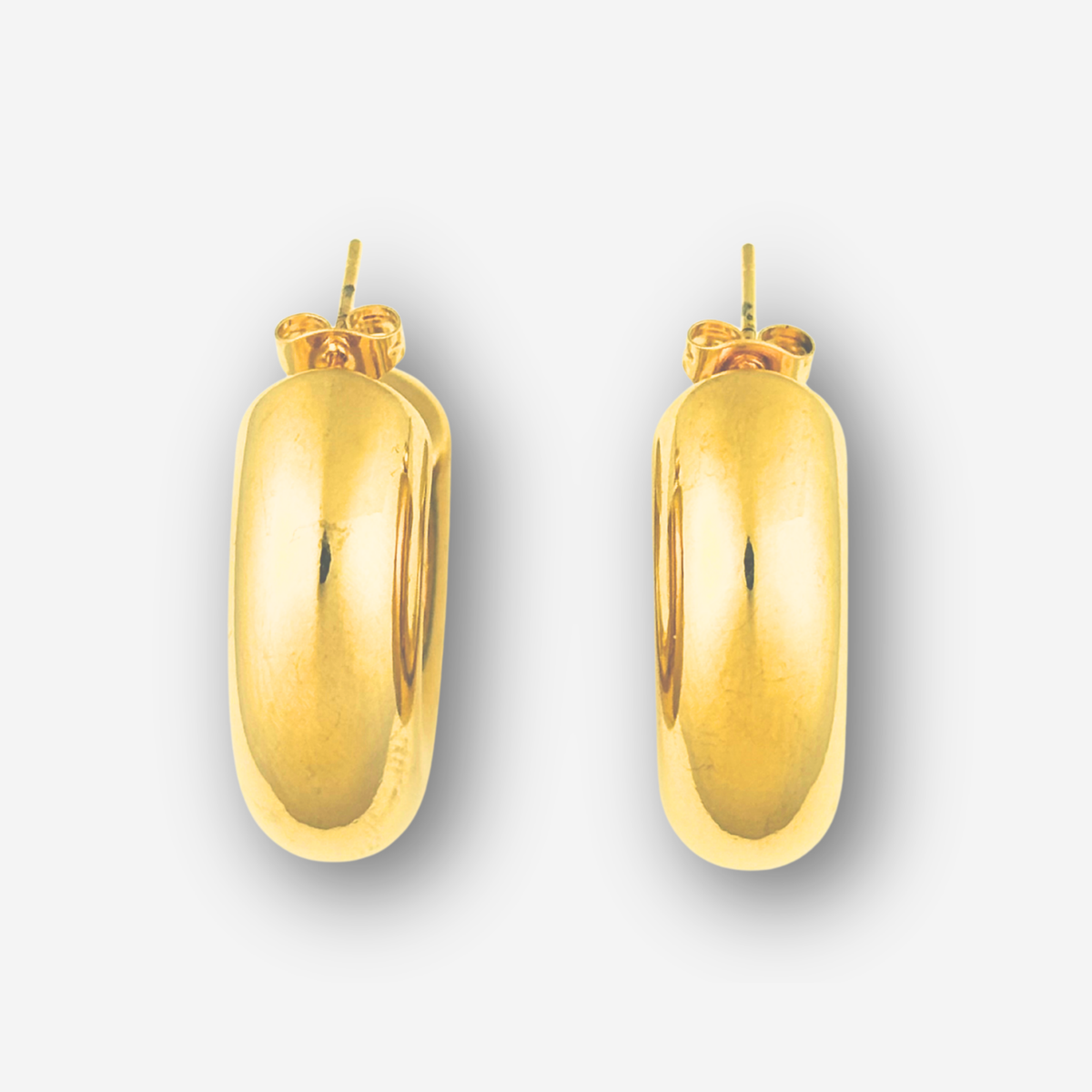 Pair of gold hoop earrings on a light gray background