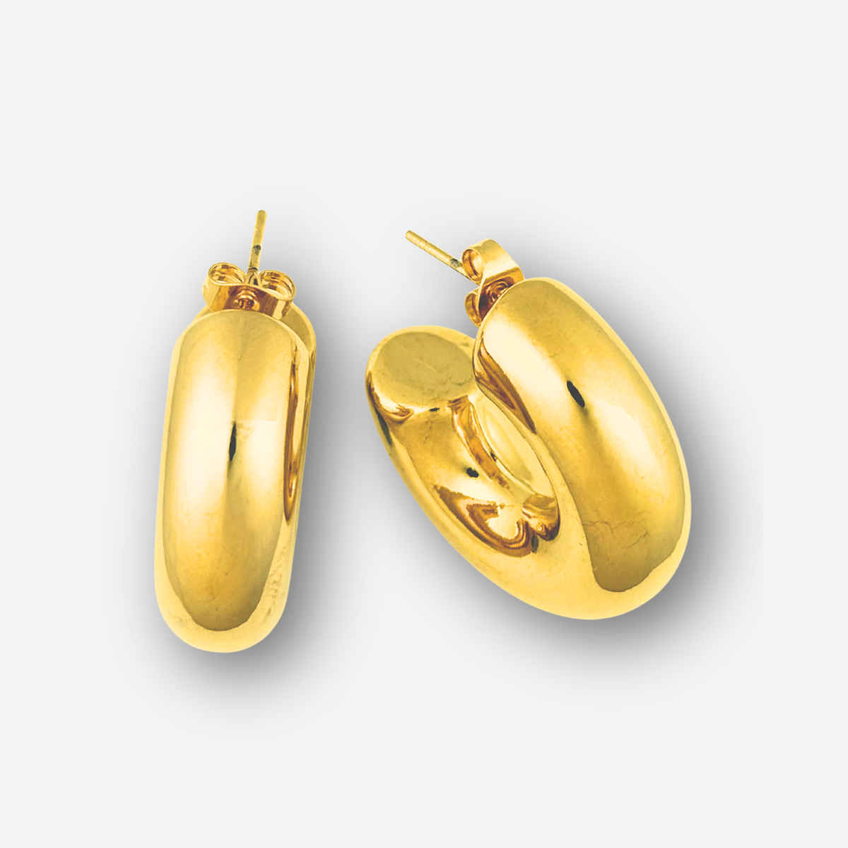Pair of gold hoop earrings on a white background