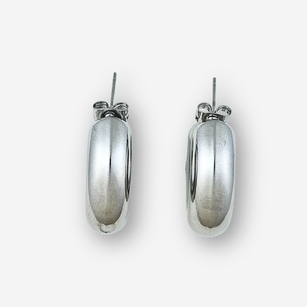 Silver hoop earrings on a light grey background
