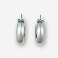 Silver hoop earrings on a light grey background