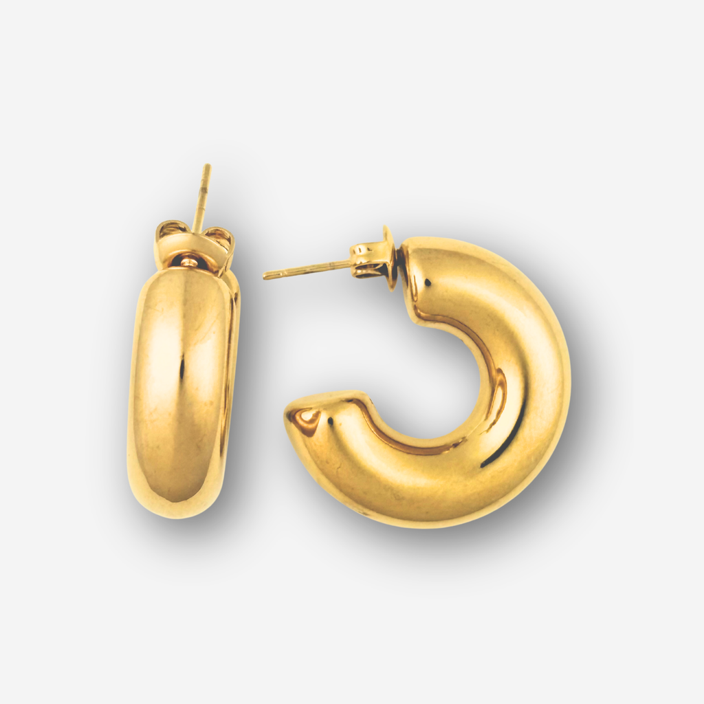 Gold hoop earrings on a light gray background