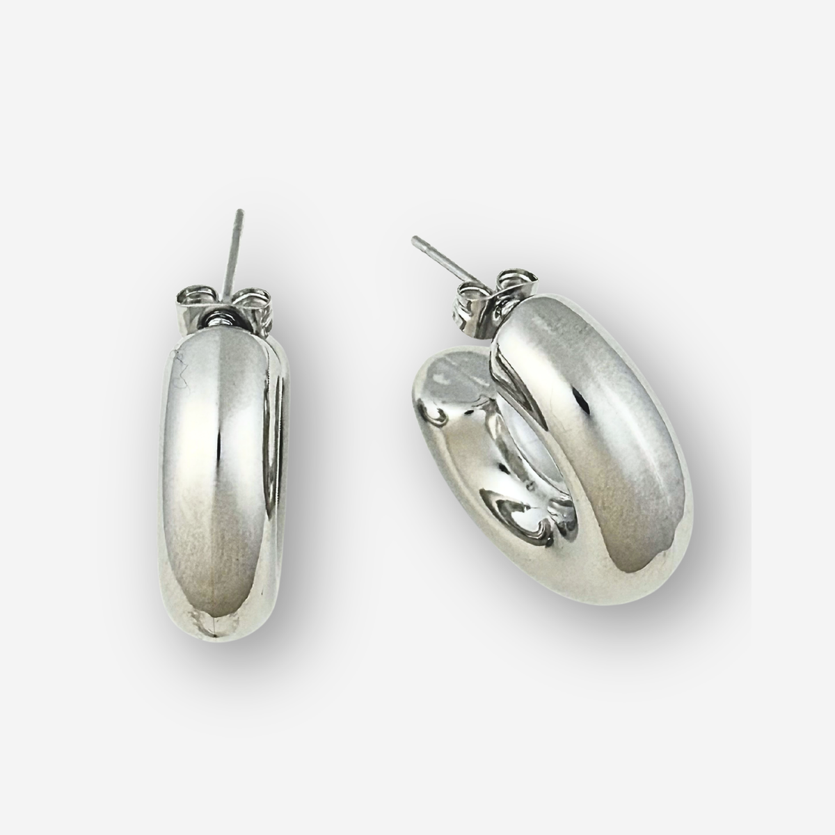 Pair of silver hoop earrings on a white background