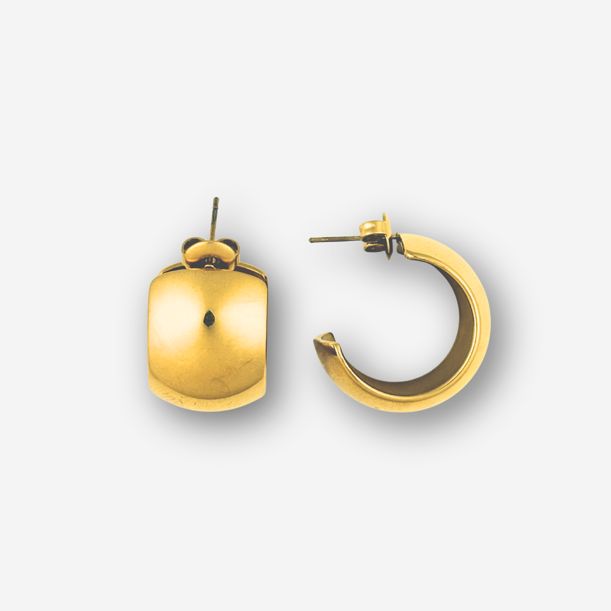 Two gold earrings on a white background
