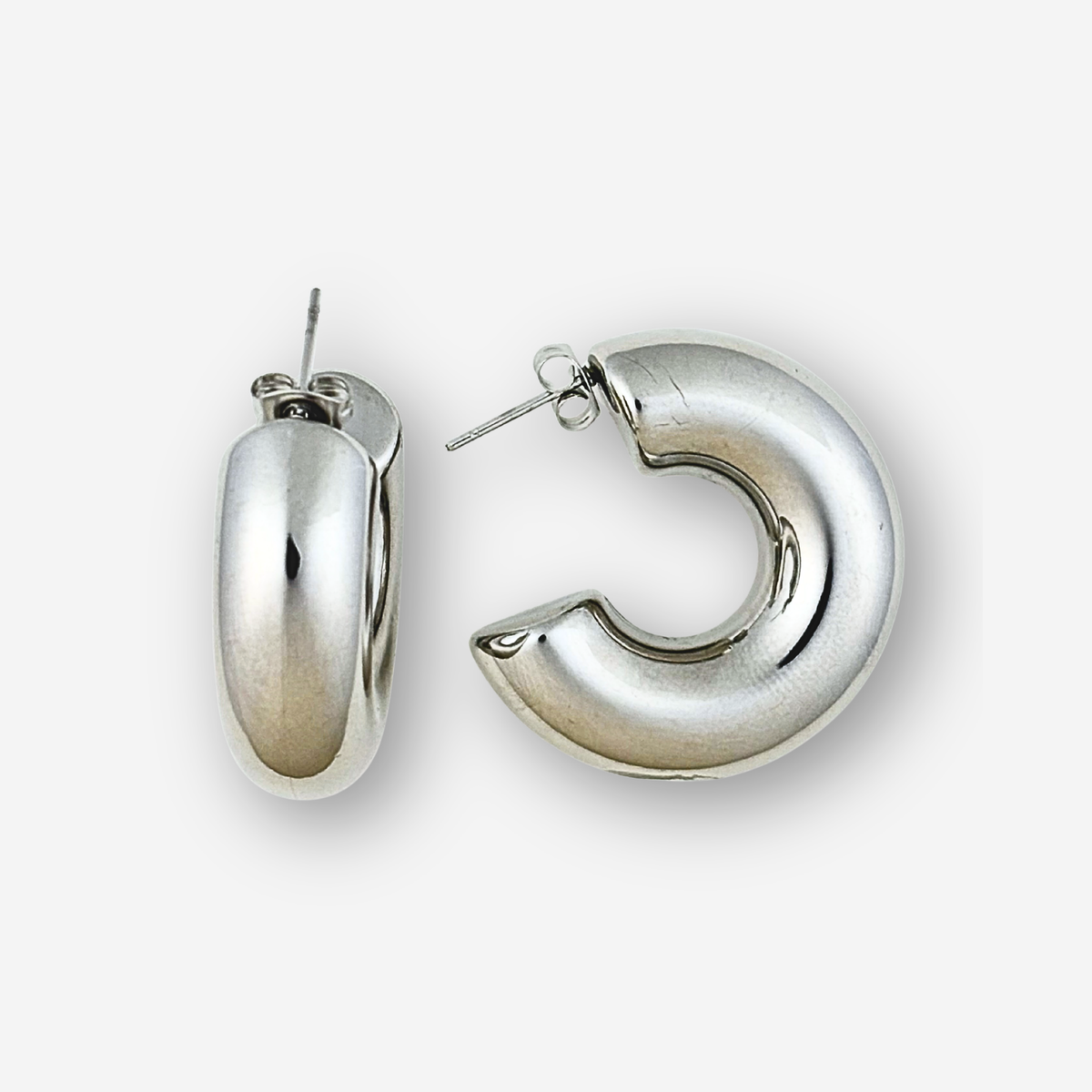 Pair of silver hoop earrings on a white background
