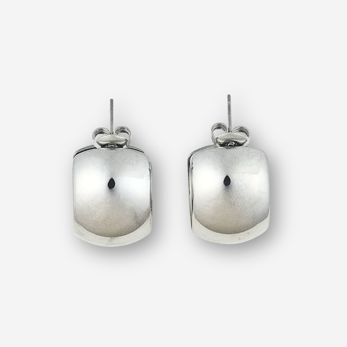 Pair of silver hoop earrings on a light grey background