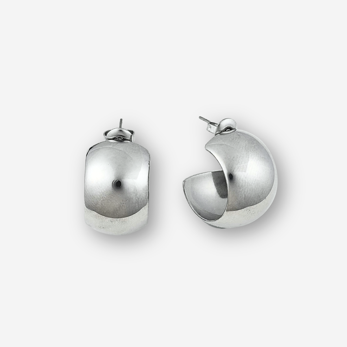 Pair of silver hoop earrings on a light grey background