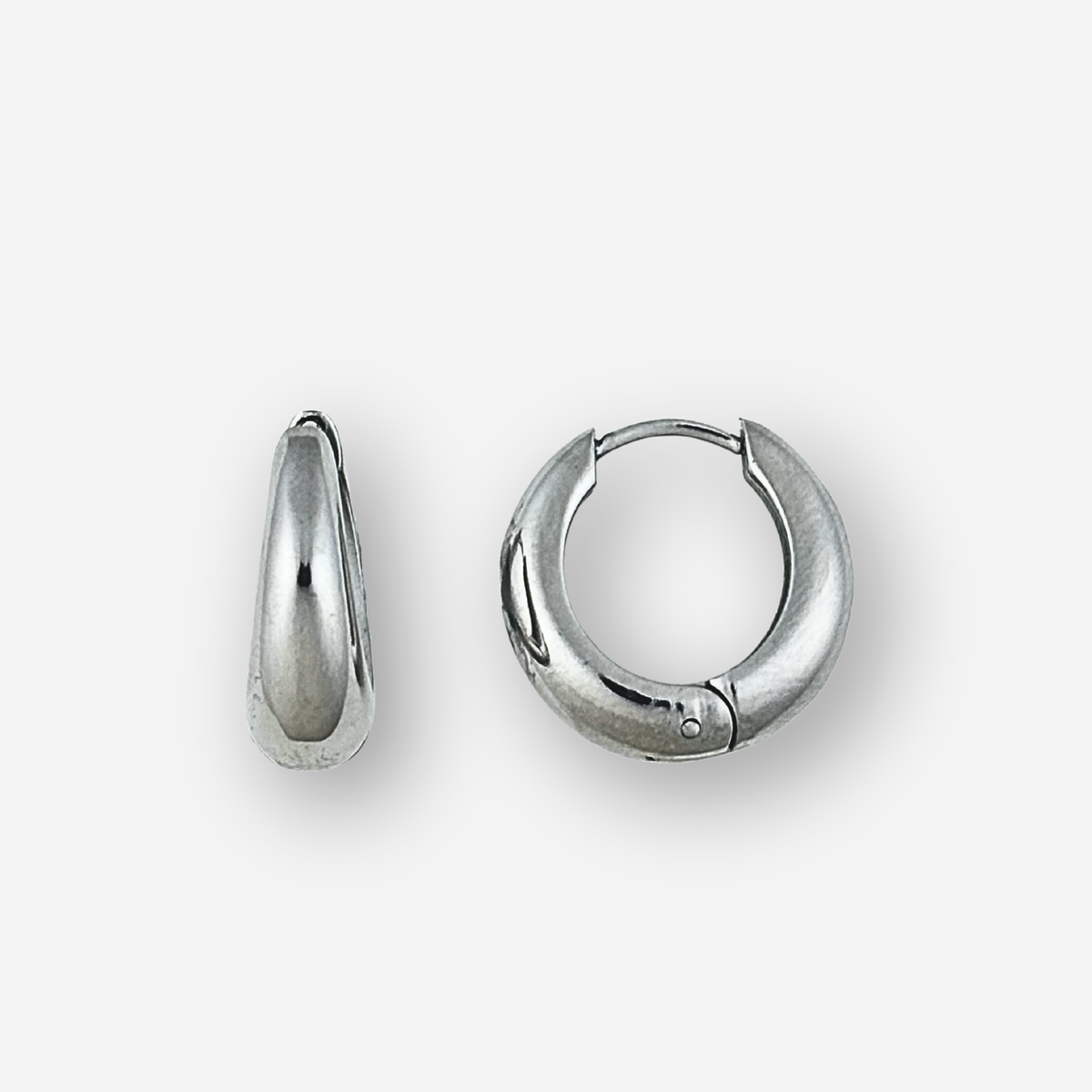 Medium size silver hoop earrings on  light grey background