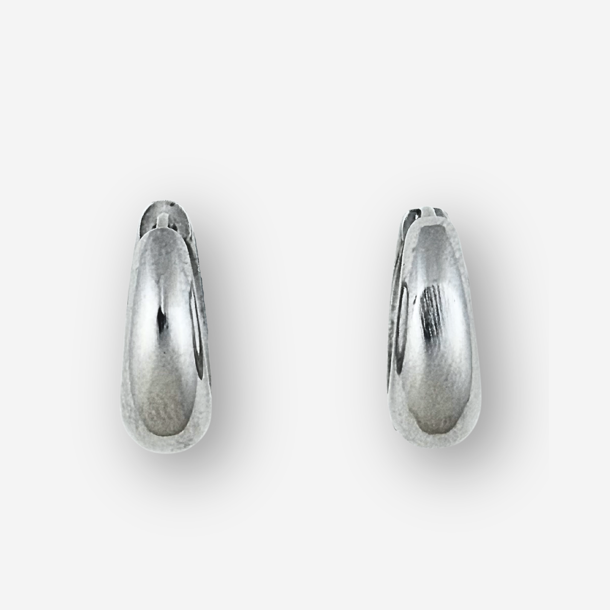 Large size silver hoop earrings on a light grey background
