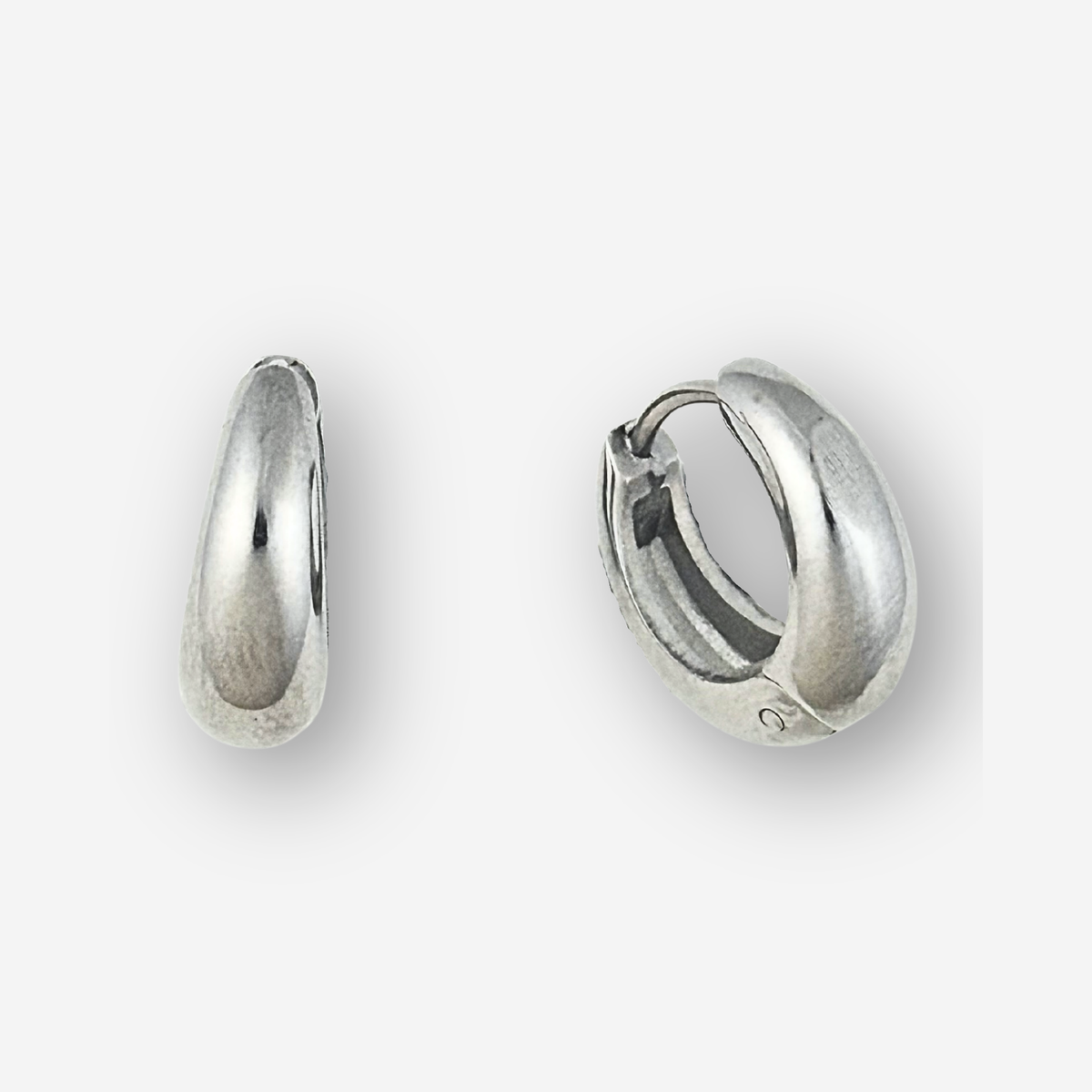 Large size silver hoop earrings on a light grey background