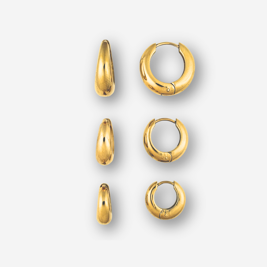 Set of gold hoop earrings on a white background