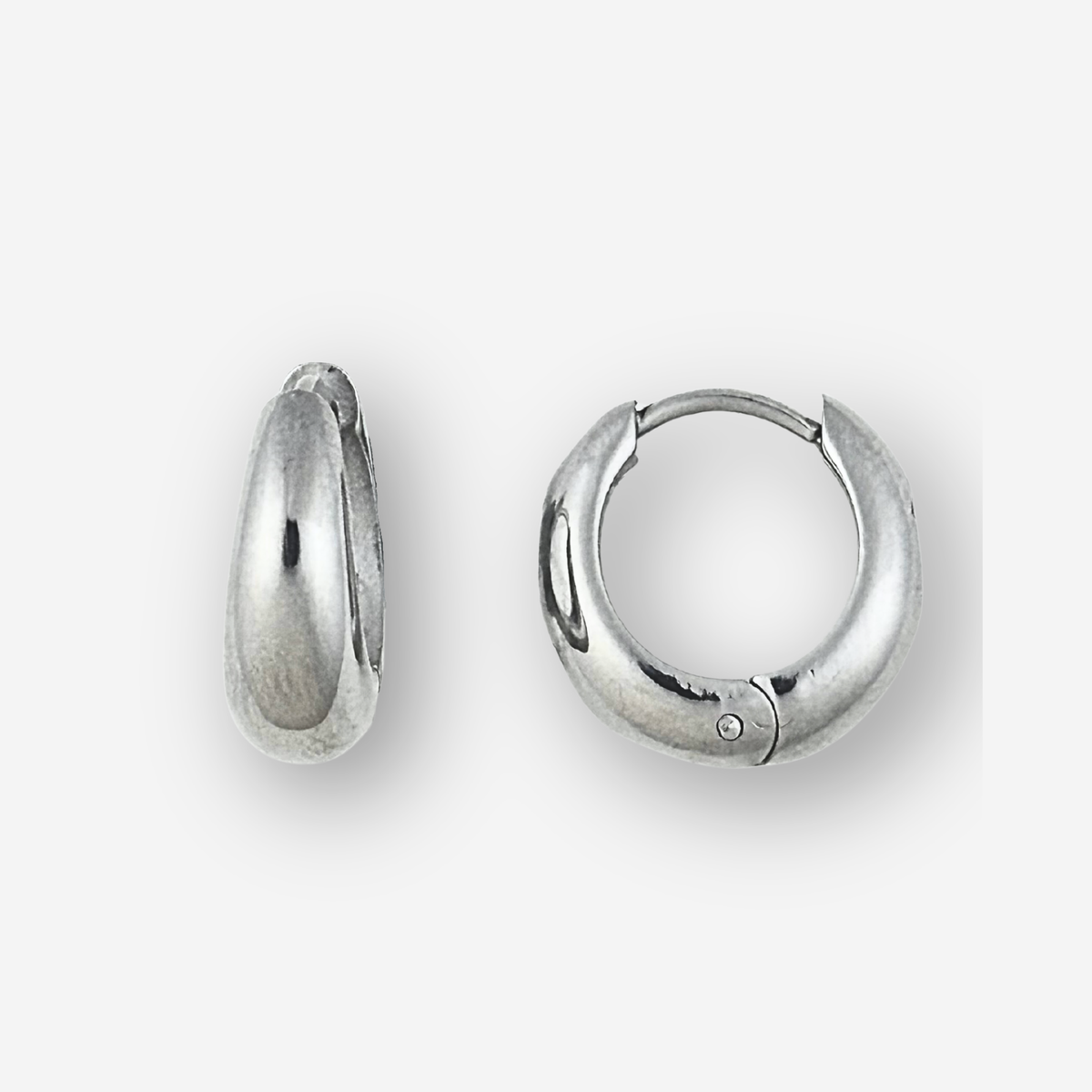 Large size silver hoop earrings on a light grey background