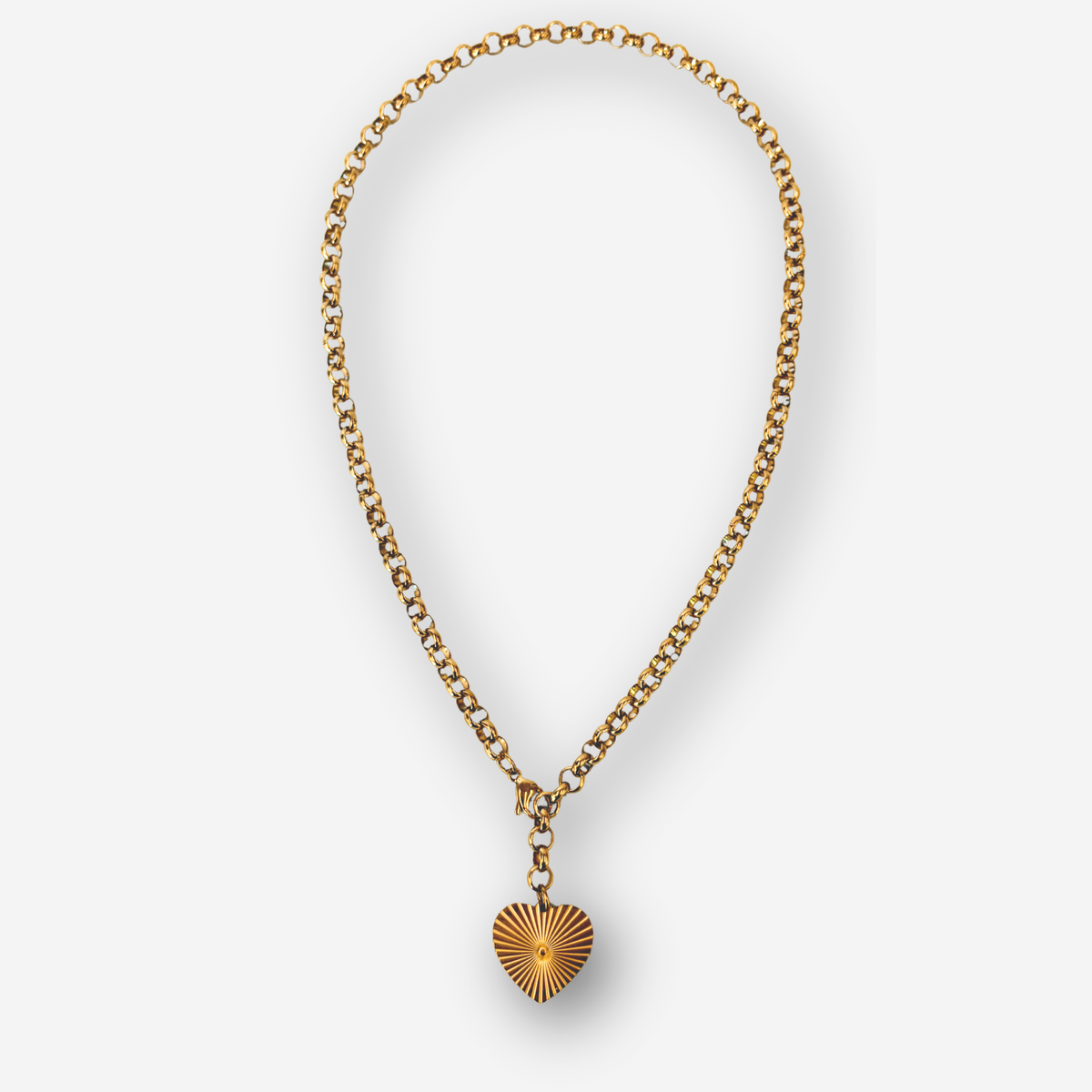 A gold chain necklace with a sunburst heart pendant, displayed against a clean white background.
