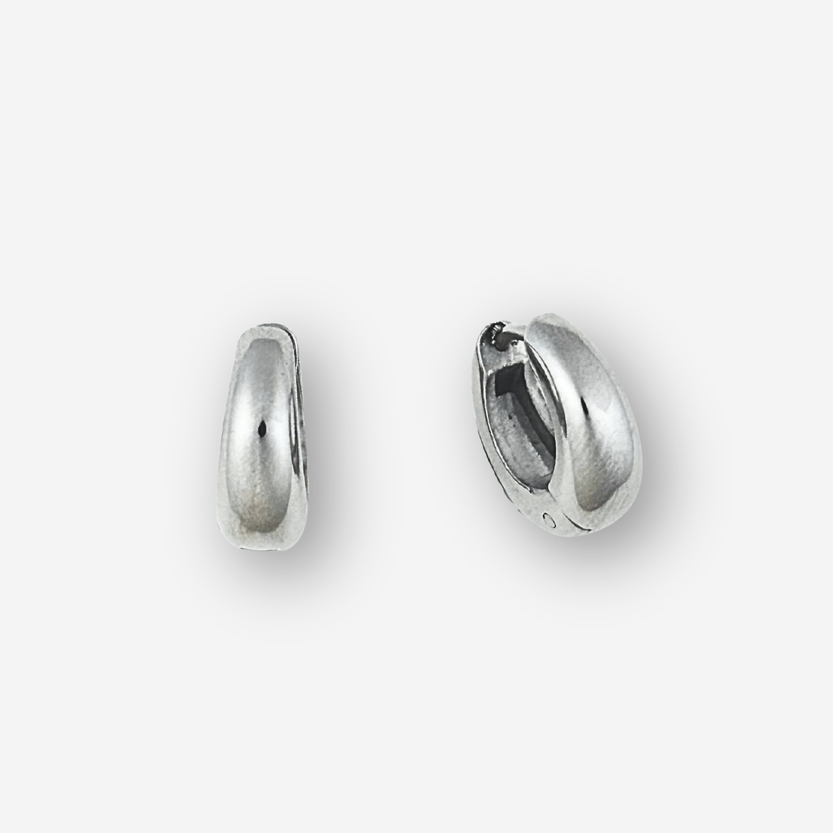 Small silver hoop earrings on a light grey background