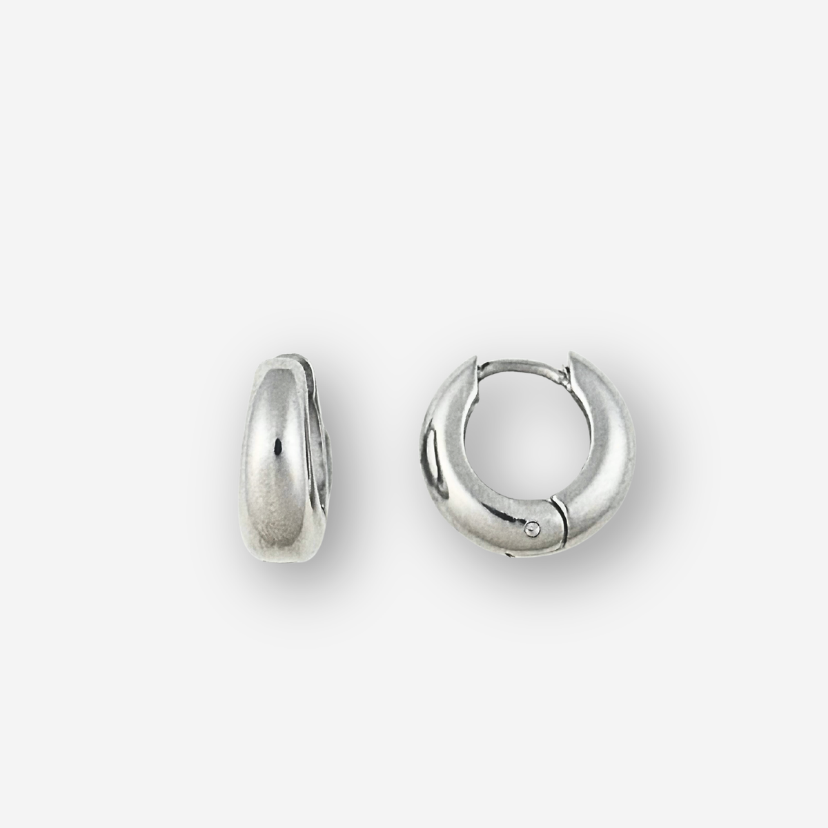 Small silver hoop earrings on a light grey background