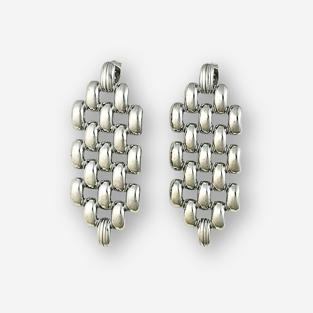 Pair of silver drop earrings on a white background