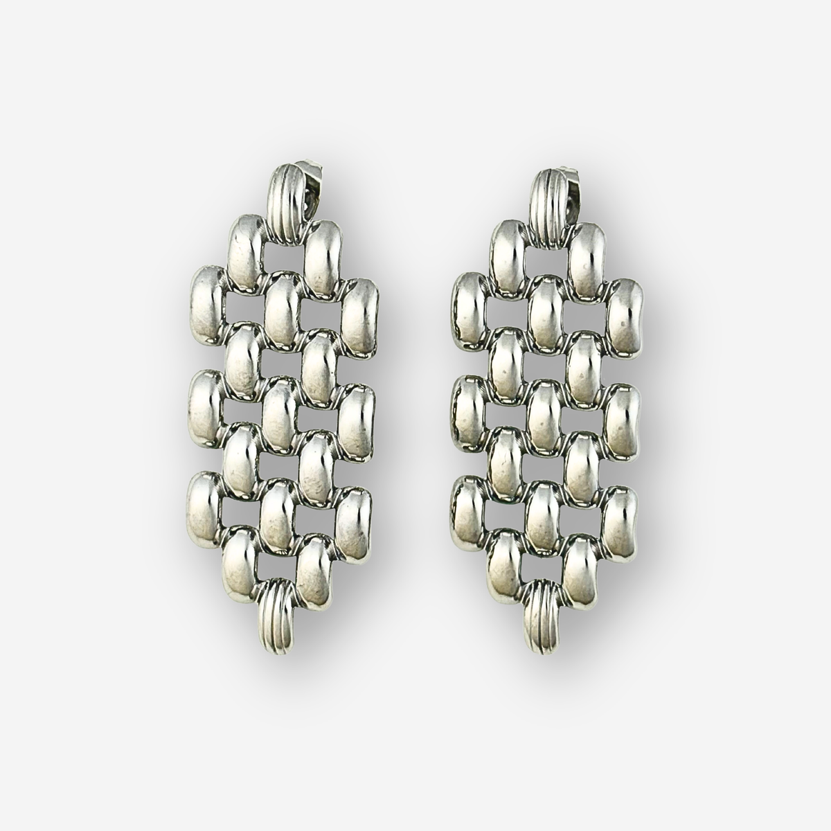 Pair of silver drop earrings on a white background