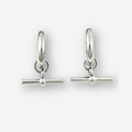 A pair of polished silver huggie hoop earrings with a toggle bar clasp, displayed on a clean light gray background.