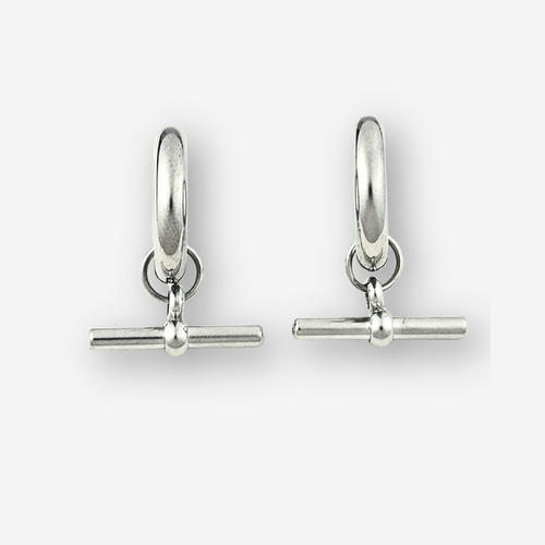 A pair of polished silver huggie hoop earrings with a toggle bar clasp, displayed on a clean light gray background.