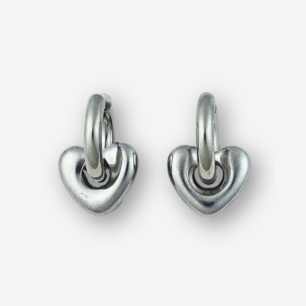 Pair of silver heart-shaped hoop earrings on a white background