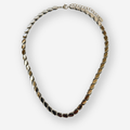 A silver toned metal necklace with a textured, overlapping leaf or petal-like chain design, displayed on a clean white background.