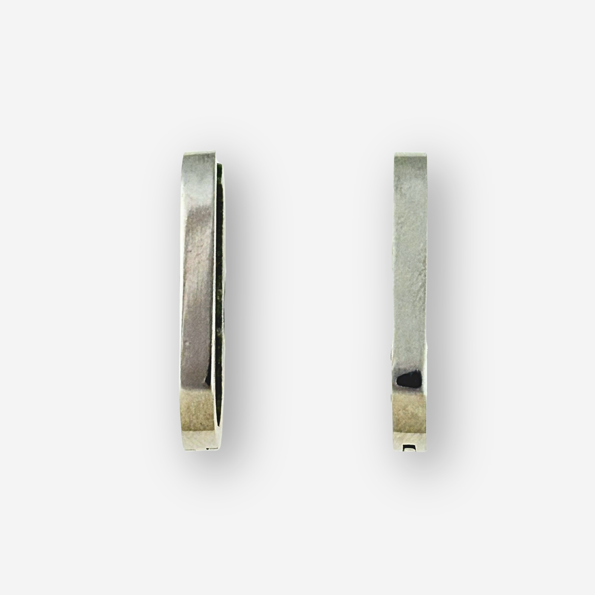 Pair of silver hoop earrings on a white background