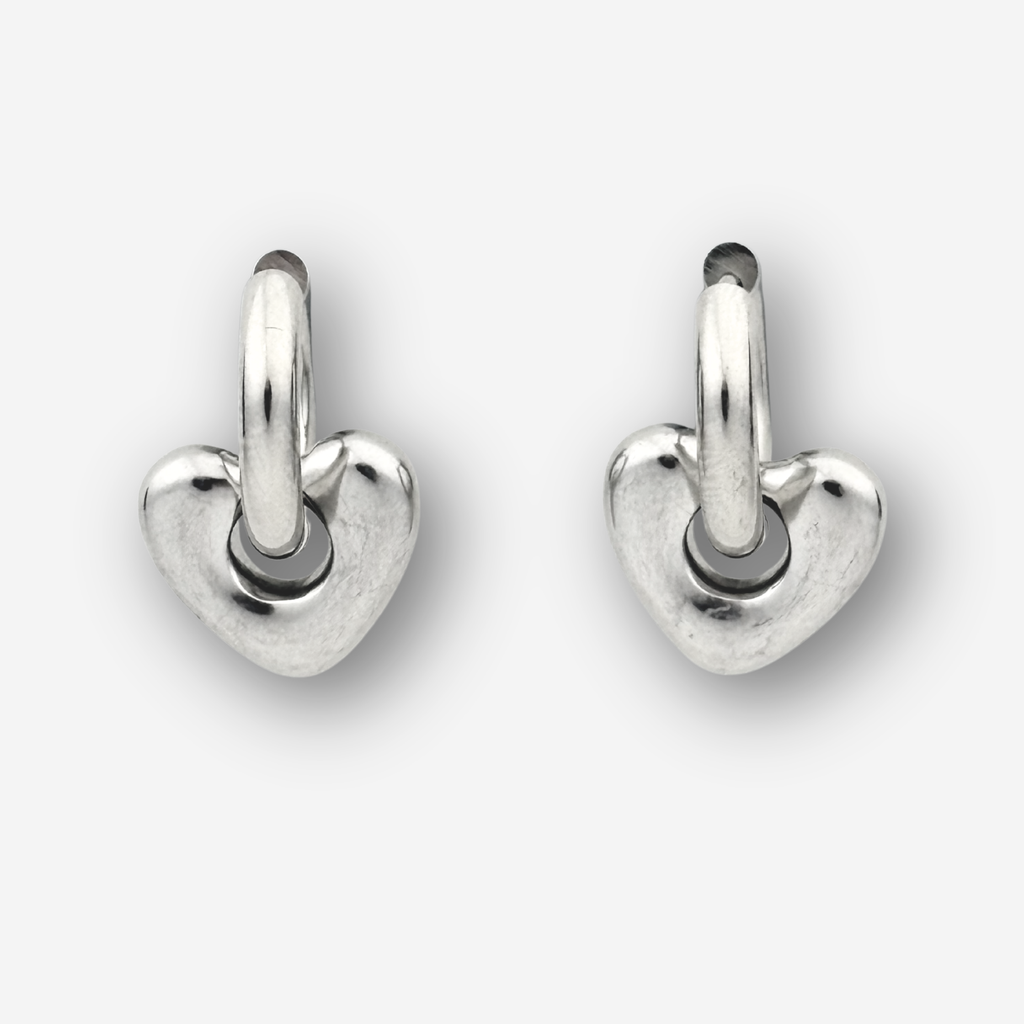 Silver heart shaped hoops on a light grey background