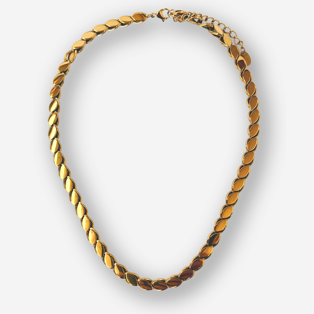 A gold chain necklace with a distinctive textured, overlapping leaf or oval link design, shown against a light gray background.