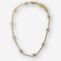 A gold chain necklace featuring infinity shaped links, displayed on a clean light gray background.