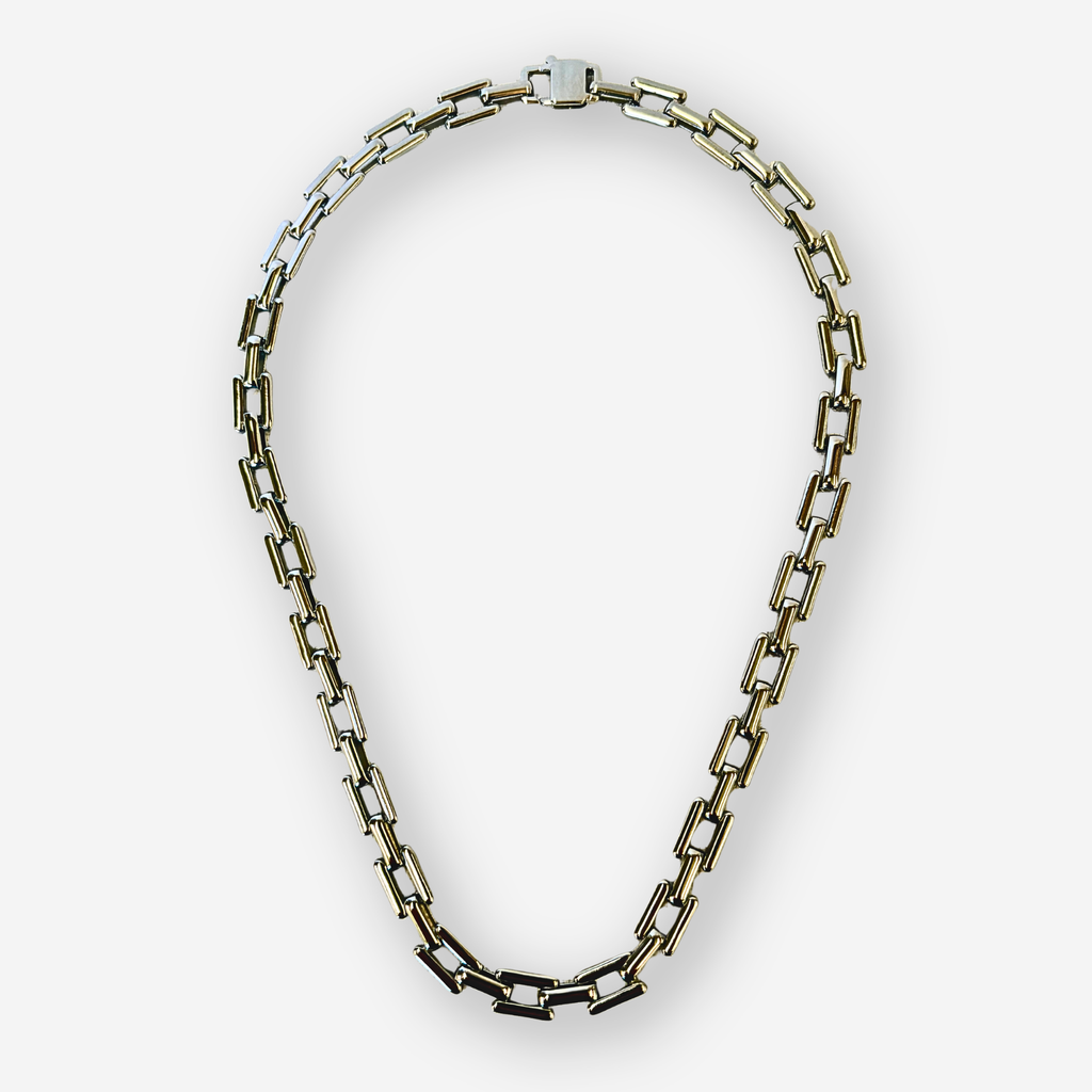 A chunky link chain necklace with silver rectangle links, displayed on a clean light gray background.