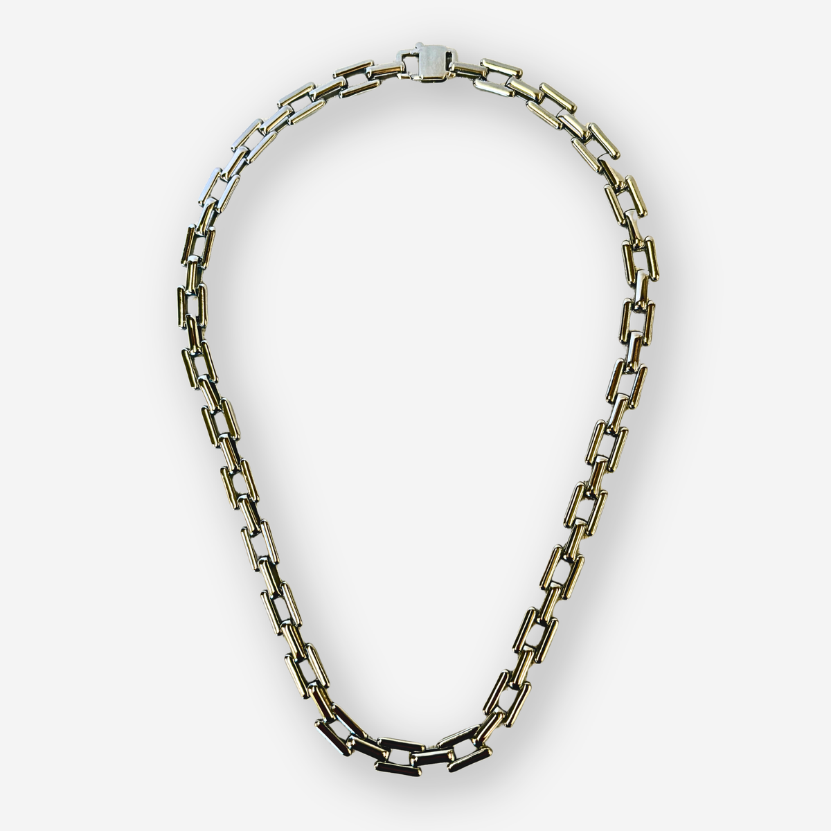 A chunky link chain necklace with silver rectangle links, displayed on a clean light gray background.