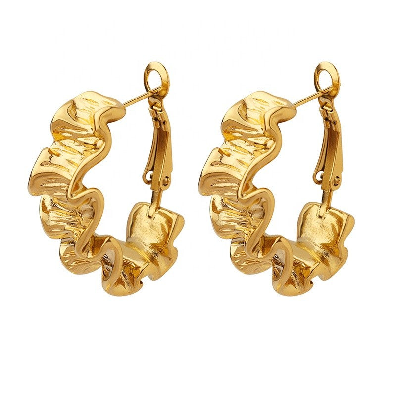 Pair of gold hoop earrings on a white background