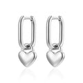 Silver heart-shaped hoop earrings on a white background