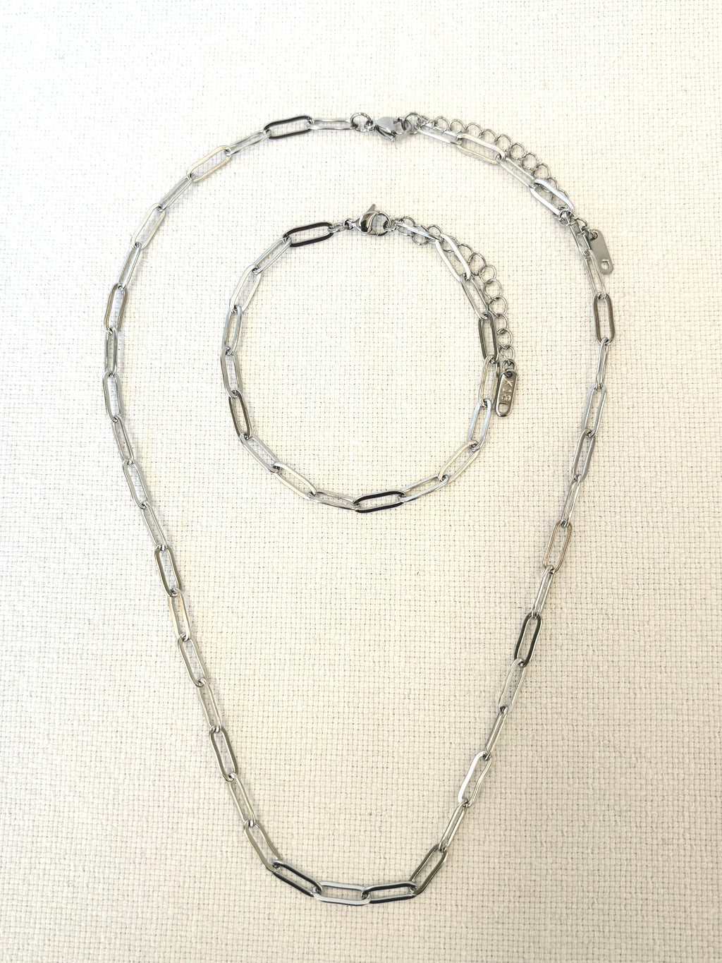 Sienna Paperclip Chain Silver Bracelet and necklace on light beige background