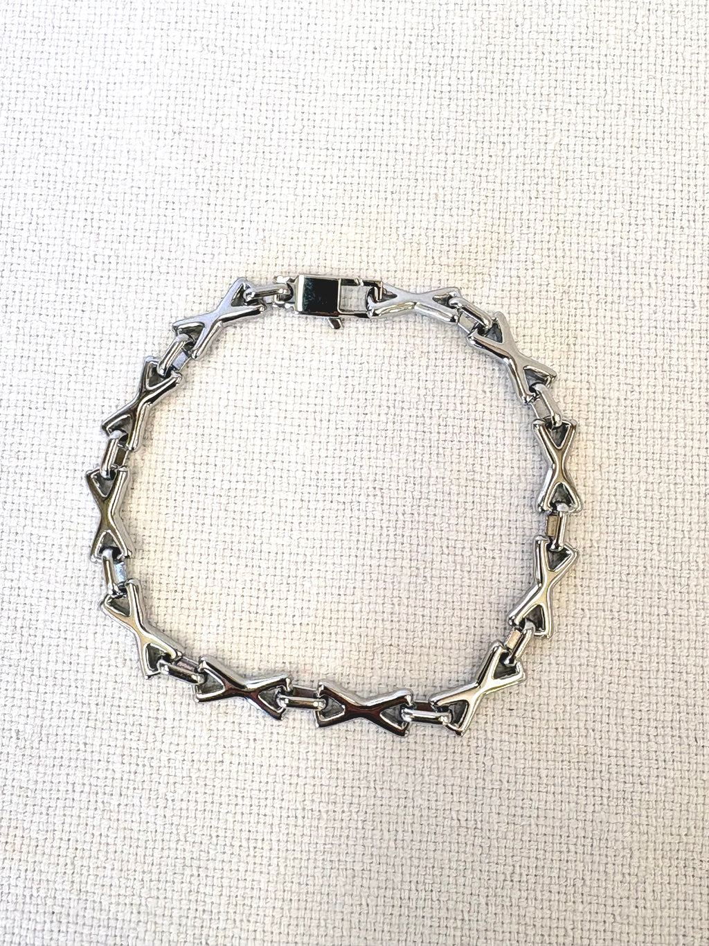 XOXO Silver Bracelet on a neutral background