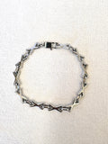 XOXO Silver Bracelet on a neutral background