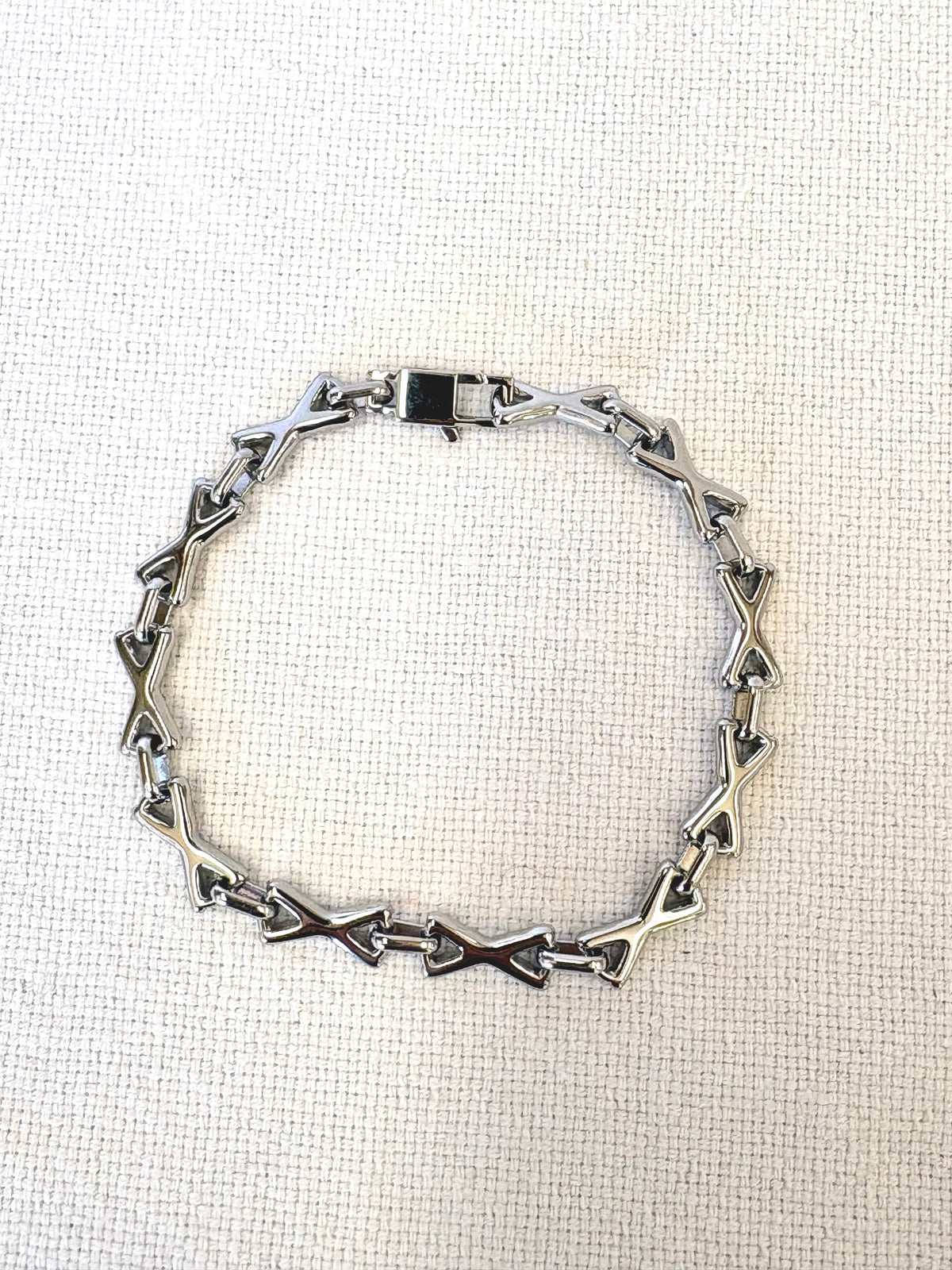 XOXO Silver Bracelet on a neutral background