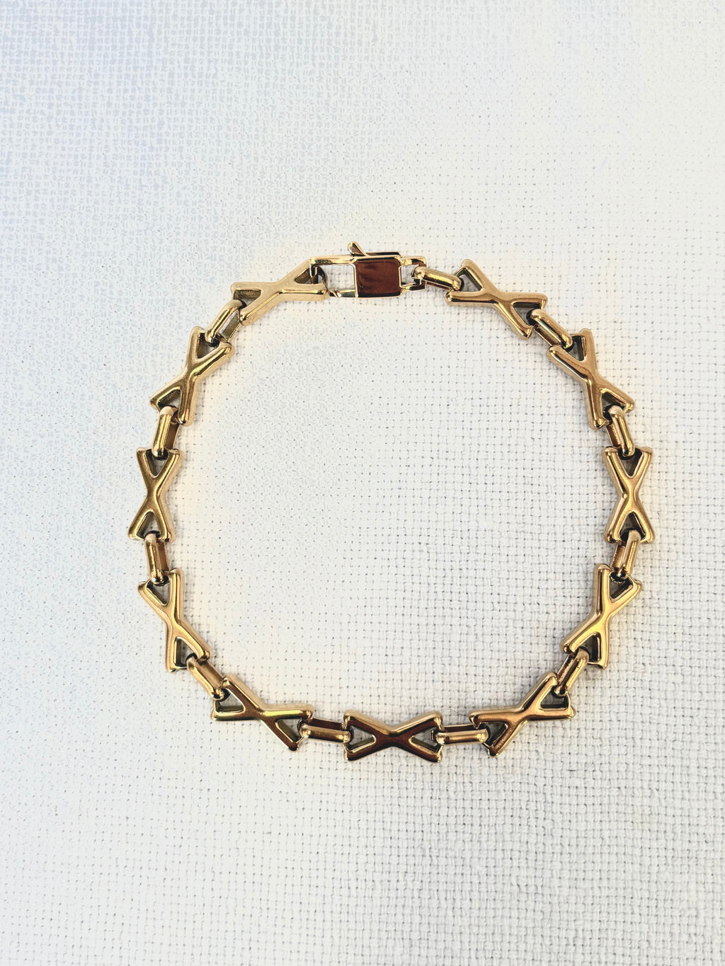 XOXO Gold Bracelet on a neutral background