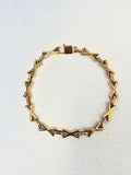 XOXO Gold Bracelet on a neutral background