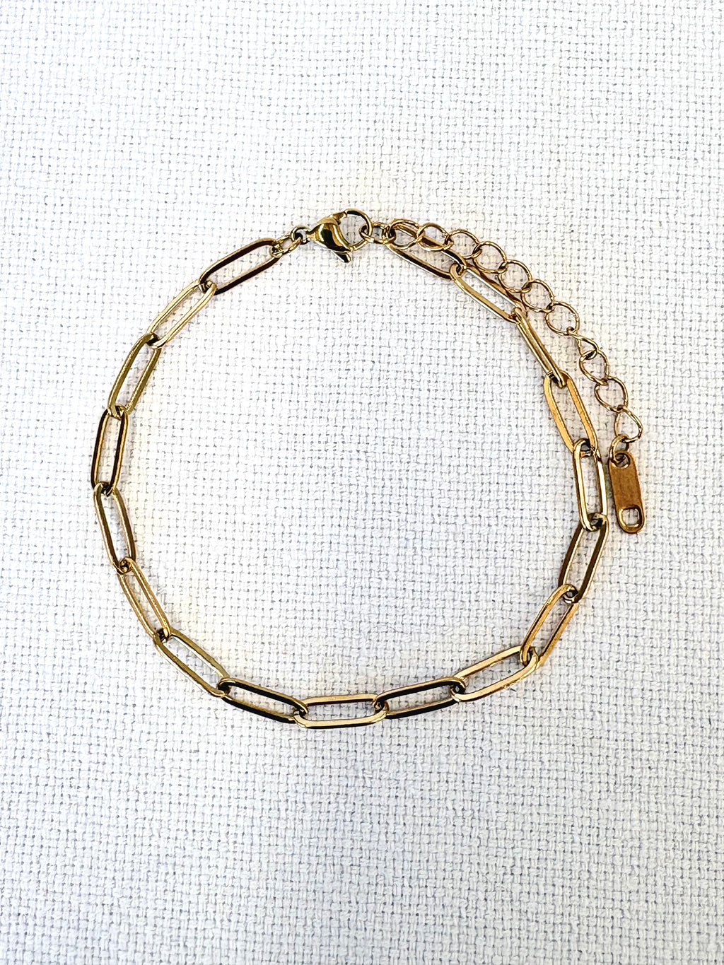 Sienna Paperclip Chain Gold Bracelet on a neutral background